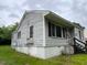 Side view of a single-story home featuring horizontal siding and lawn at 246 Keene St, Henderson, NC 27536