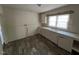 Functional kitchen featuring white cabinetry, laminate counters and a double sink at 246 Keene St, Henderson, NC 27536
