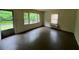 Neutral living room with dark hardwood floors, front door and a window with natural light at 246 Keene St, Henderson, NC 27536