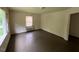 Neutral living room with dark hardwood floors and a window with natural light at 246 Keene St, Henderson, NC 27536