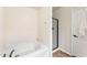 Bright bathroom features a soaking tub and a separate glass-enclosed shower at 2530 Girvan Dr, Fuquay Varina, NC 27526