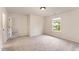 Bedroom with neutral walls and carpet with an adjoining open door at 2530 Girvan Dr, Fuquay Varina, NC 27526