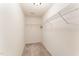 Walk-in closet with metal shelving and carpet flooring at 2530 Girvan Dr, Fuquay Varina, NC 27526