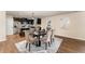 Dining area featuring a modern table, with the kitchen in the background at 2530 Girvan Dr, Fuquay Varina, NC 27526