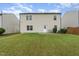 Back exterior view of the home with siding, a door, and a well-maintained lawn at 2530 Girvan Dr, Fuquay Varina, NC 27526