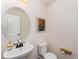 Cozy half bathroom with a modern sink, mirror, and decorative wall art at 2530 Girvan Dr, Fuquay Varina, NC 27526