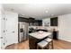 Stylish kitchen with granite countertops, stainless steel appliances, and dark cabinetry at 2530 Girvan Dr, Fuquay Varina, NC 27526