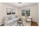 Inviting living room with neutral tones, a modern rug, and bright natural lighting at 2530 Girvan Dr, Fuquay Varina, NC 27526