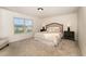 Well-lit main bedroom boasts a large window and plush carpeting at 2530 Girvan Dr, Fuquay Varina, NC 27526