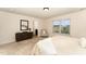 Main bedroom with neutral walls and carpet, dresser and light-filled window at 2530 Girvan Dr, Fuquay Varina, NC 27526