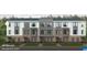 Modern townhome elevation with symmetrical windows, brick accents, and manicured landscaping at 2810 Kempthorne Rd # 60, Cary, NC 27519