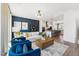 Bright living room featuring a modern chandelier, hardwood floors, and comfortable seating at 2810 Kempthorne Rd # 60, Cary, NC 27519