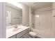 Well-lit bathroom features a shower-tub combo, single sink vanity with gray cabinets, and a toilet at 301 New Twin Br Ct, Smithfield, NC 27577