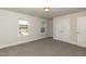 Spacious carpeted bedroom with large windows and a closet at 301 New Twin Br Ct, Smithfield, NC 27577