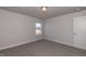 Carpeted bedroom with a single window allowing natural light to illuminate the neutral walls at 301 New Twin Br Ct, Smithfield, NC 27577