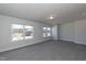Spacious carpeted bedroom with natural light pouring in from two large windows at 301 New Twin Br Ct, Smithfield, NC 27577