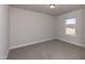 Carpeted bedroom with a single window allowing natural light to illuminate the neutral walls at 301 New Twin Br Ct, Smithfield, NC 27577