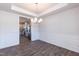 Dining room with hardwood floors, neutral walls, and a chandelier, flowing into the kitchen at 301 New Twin Br Ct, Smithfield, NC 27577