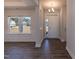 Bright foyer featuring elegant wood flooring, neutral walls, and ample natural light from a nearby window at 301 New Twin Br Ct, Smithfield, NC 27577