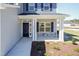Inviting front porch with stone accents, white columns, and manicured landscaping, offering a warm welcome at 301 New Twin Br Ct, Smithfield, NC 27577