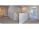 Neutral-toned hallway with carpet and white trim, leading to bedrooms and bathrooms at 301 New Twin Br Ct, Smithfield, NC 27577