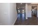 Hallway featuring wood floors, neutral walls, access to the kitchen, stairs to the second floor and a back door at 301 New Twin Br Ct, Smithfield, NC 27577