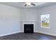 Bright living room featuring a fireplace, ceiling fan, and a window offering natural light at 301 New Twin Br Ct, Smithfield, NC 27577