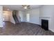 Spacious living room with wood floors, fireplace, staircase, ceiling fan, and neutral paint for a cozy feel at 301 New Twin Br Ct, Smithfield, NC 27577