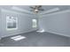 Bright main bedroom with tray ceiling, a ceiling fan, and large windows offering plenty of light at 301 New Twin Br Ct, Smithfield, NC 27577