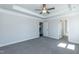 Main bedroom featuring a tray ceiling and natural light from the windows and the two doorways at 301 New Twin Br Ct, Smithfield, NC 27577