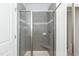 Modern shower with gray tile, a built-in seat, and sleek glass doors for a luxurious experience at 301 New Twin Br Ct, Smithfield, NC 27577