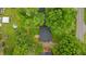 An aerial view shows a well-manicured yard with mature trees surrounding the brick home at 307 Pine Tree Rd, Oxford, NC 27565