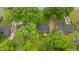 This aerial view showcases a beautiful tree-lined property with a well-maintained lawn and homes at 307 Pine Tree Rd, Oxford, NC 27565
