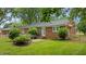 Brick home featuring a cozy backyard bench and well-maintained lawn, ideal for relaxation at 307 Pine Tree Rd, Oxford, NC 27565