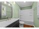 Bathroom with a bathtub and shower combo, single vanity, and green walls at 307 Pine Tree Rd, Oxford, NC 27565