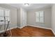 This bedroom features wood flooring, two windows with shutters, and neutral paint at 307 Pine Tree Rd, Oxford, NC 27565