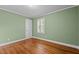 This bedroom features wood flooring, one window with shutters, and neutral paint at 307 Pine Tree Rd, Oxford, NC 27565