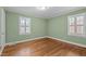This bedroom features wood flooring, two windows with shutters, and neutral paint at 307 Pine Tree Rd, Oxford, NC 27565