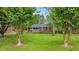 Quaint brick home with a lush green lawn, framed by mature trees, highlighting its inviting curb appeal at 307 Pine Tree Rd, Oxford, NC 27565