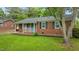 Classic brick house with a pop of color from the blue front door and well-maintained landscaping at 307 Pine Tree Rd, Oxford, NC 27565