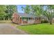 Traditional brick home with a neatly kept lawn, accented by a vibrant blue door and black shutters at 307 Pine Tree Rd, Oxford, NC 27565