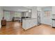 Modern kitchen with granite island, stainless appliances, and hardwood floors, connected to a cozy living room at 307 Pine Tree Rd, Oxford, NC 27565