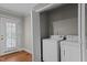 A well-lit laundry room with modern appliances and a view to the outside at 307 Pine Tree Rd, Oxford, NC 27565
