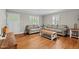 Living room featuring hardwood floors, two sofas, two windows with shutters, and natural light at 307 Pine Tree Rd, Oxford, NC 27565