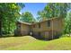 Exterior rear view displaying the home's design, brick foundation, and backyard at 3216 Green Valley Dr, Sanford, NC 27330