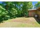 Level backyard featuring mature trees and landscaping, perfect for outdoor activities at 3216 Green Valley Dr, Sanford, NC 27330