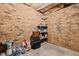 Storage room with unfinished brick walls and a simple shelving unit at 3216 Green Valley Dr, Sanford, NC 27330