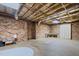 Unfinished basement with exposed ceiling, brick walls and concrete floor at 3216 Green Valley Dr, Sanford, NC 27330