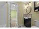 A bathroom entrance view features a modern vanity with mirror and lighting fixtures, and a toilet at 3216 Green Valley Dr, Sanford, NC 27330