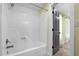 A light green painted bathroom shower and showerhead, with a white tub. features gray door at 3216 Green Valley Dr, Sanford, NC 27330